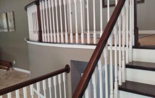 staircase with dark wood stairs and white and wood railing