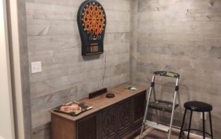 room with wooden coffee table and dart board on wall